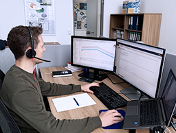 A team of engineers collaboratively working on product solutions for client inquiries, showcasing systematic problem-solving in technical applications.