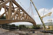 Dřevěná lávka při instalaci. Pozoruhodný projekt dřevostavby s pokročilým statickým výpočtem.