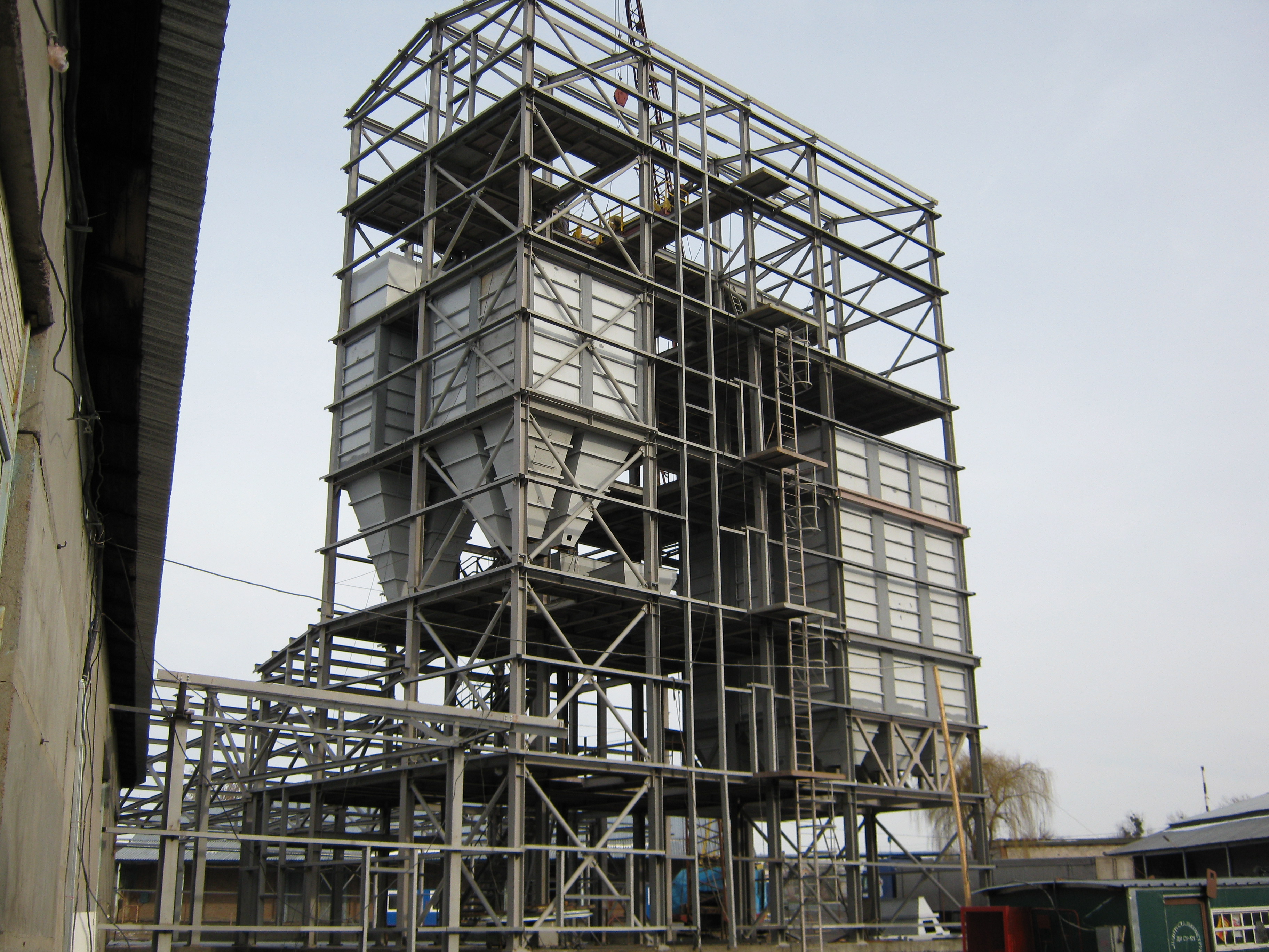 Steel structure with multiple silos shows industrial structural project in Ukraine.