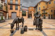 Statue de la laitière avec la plaque Plaza Trascorrales à Oviedo, entourée de bâtiments typiques