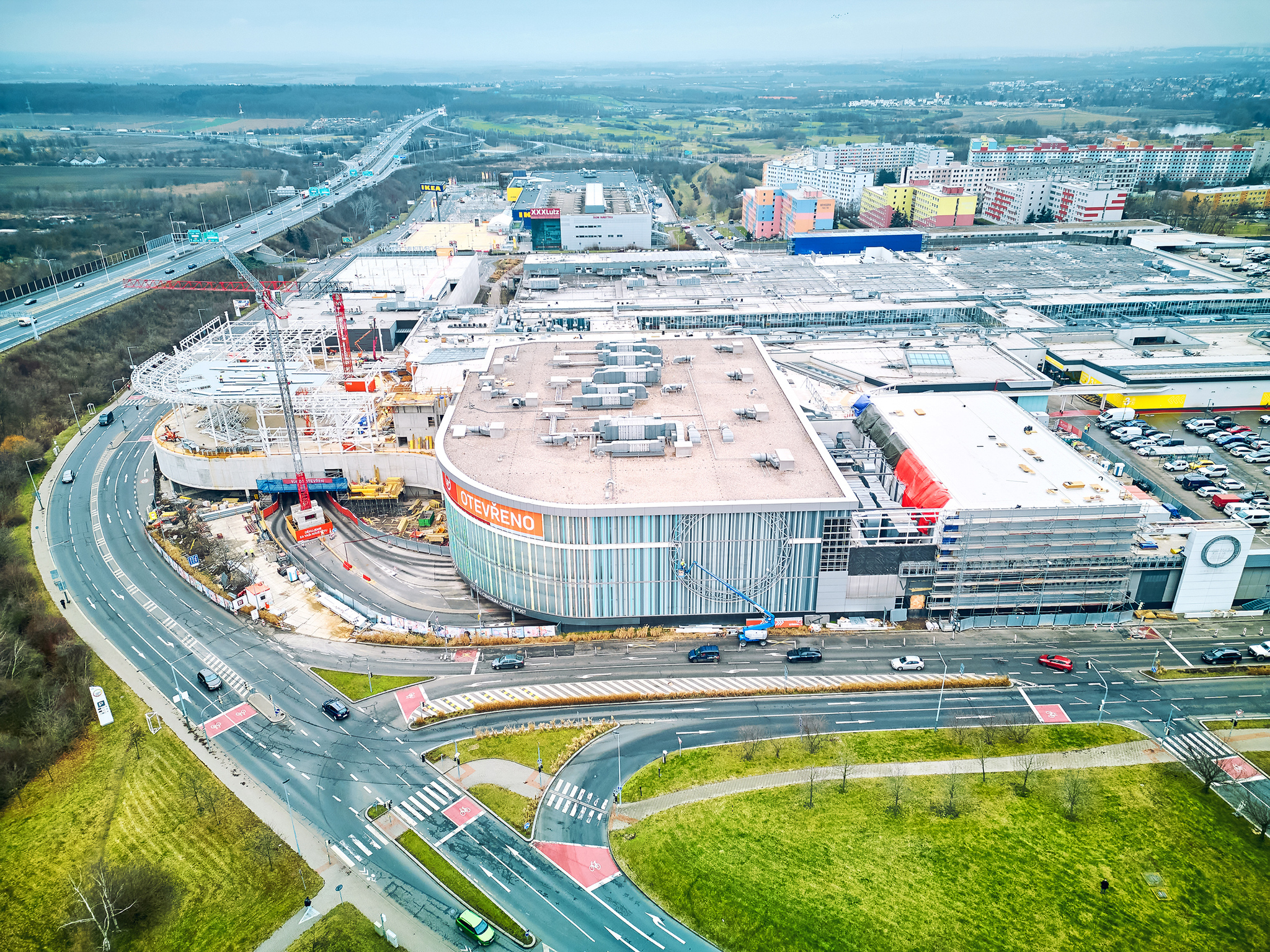 Rozbudowa północno-wschodniego strefy centrum Westfield Černý Most z przeszkloną elewacją, świetlikiem, konstrukcją stalową z dźwigarami i dachem.